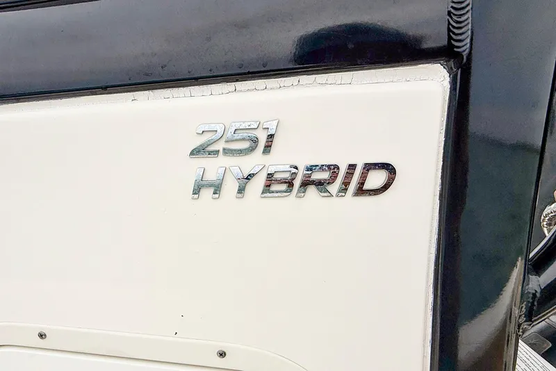 Slide: The Image of 2020 NauticStar 251 Hybrid boat emblem on white and black surface. - 21