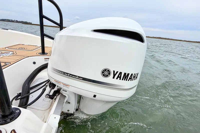 Slide: The Image of 2020 NauticStar 251 Hybrid with Yamaha outboard engine on water. - 22