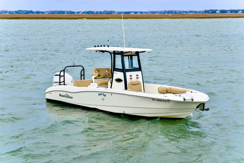 Slide: The Image of 2020 NauticStar 251 Hybrid boat on water, featuring sleek design and Yamaha engine. - 4