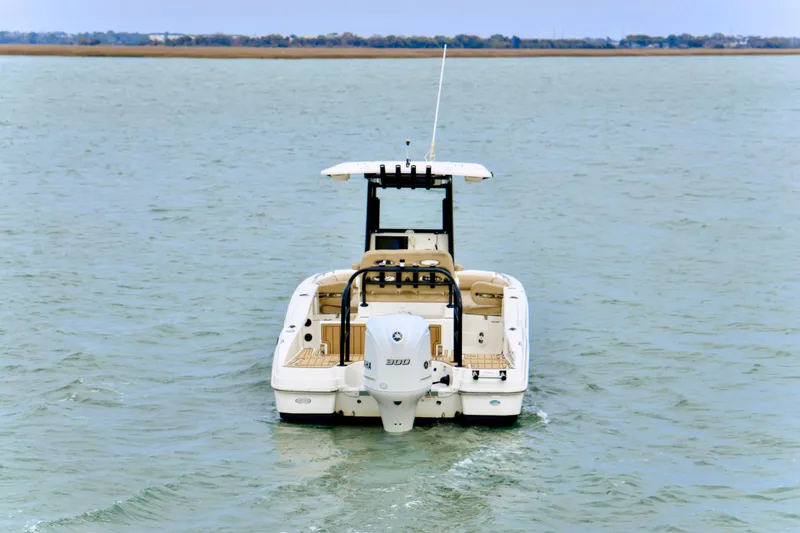 Slide: The Image of 2020 NauticStar 251 Hybrid boat on open water, rear view. - 5
