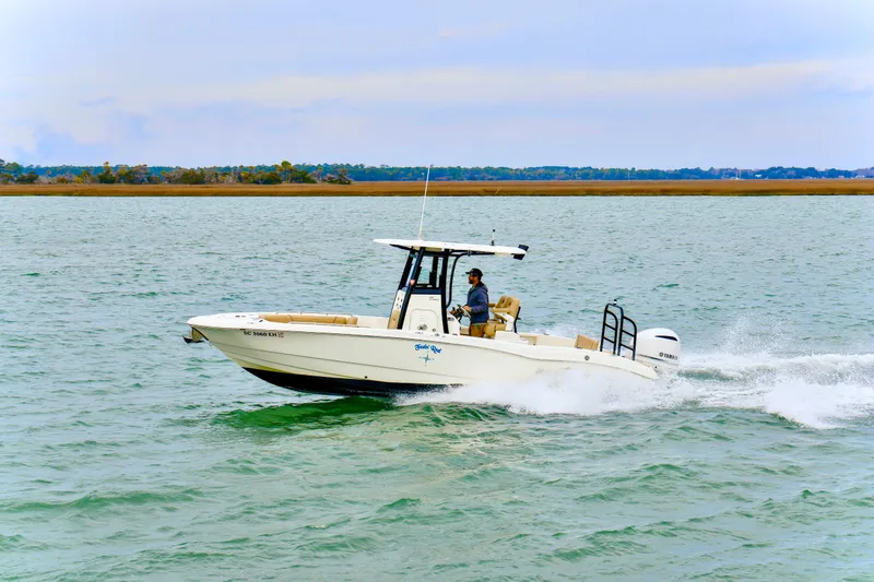 Slide: The Image of 2020 NauticStar 251 Hybrid boat cruising on open water. - 6
