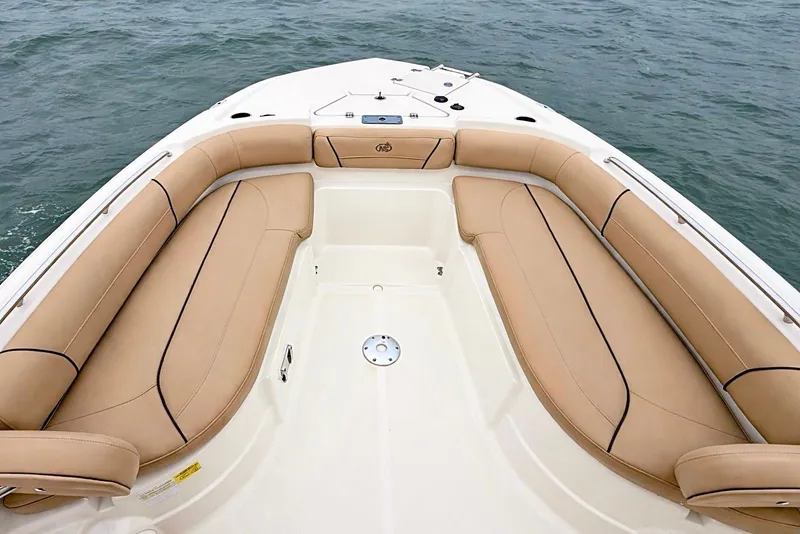 Slide: The Image of 2020 NauticStar 251 Hybrid boat with tan seating, on calm water. - 9