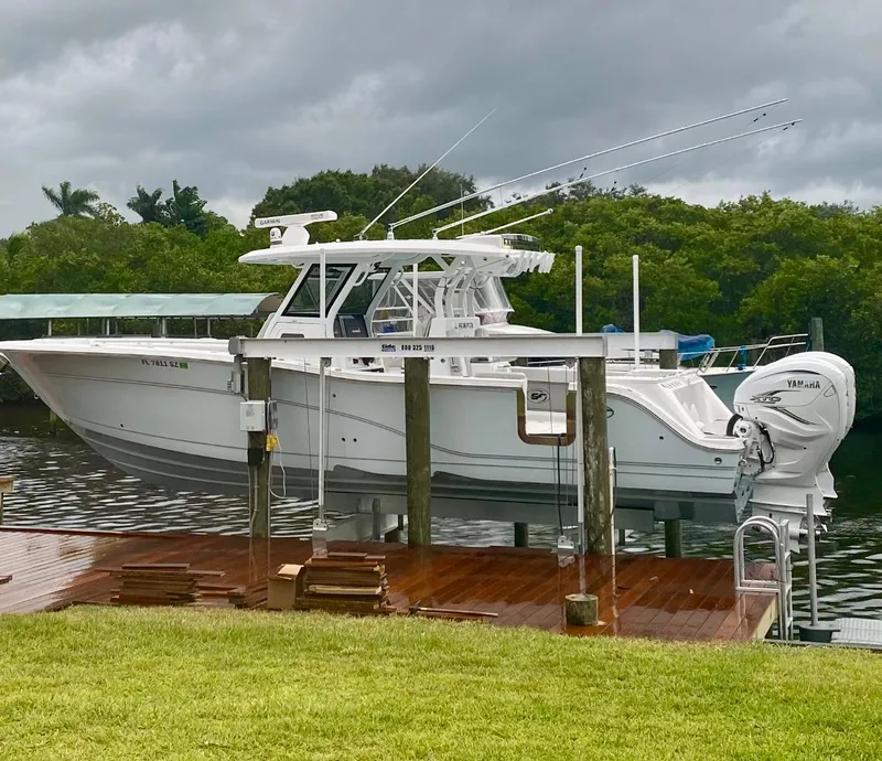 Slide: The Image of 2021 Sea Fox 368 Commander boat docked with Yamaha engines, under cloudy skies. - 2