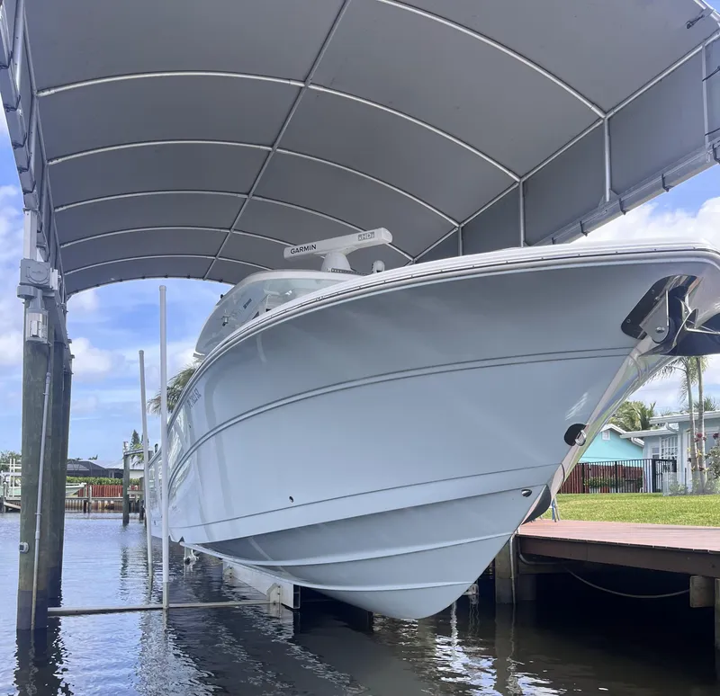 Slide: The Image of 2021 Sea Fox 368 Commander boat docked under a canopy. - 33