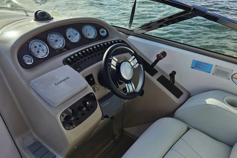 Slide: The Image of 2002 Chaparral 285 SSi boat dashboard with Garmin navigation system and steering wheel. - 13