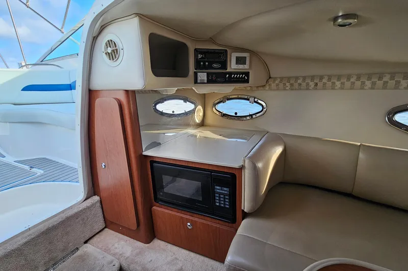 Slide: The Image of Interior of 2002 Chaparral 285 SSi boat with microwave and seating area. - 25