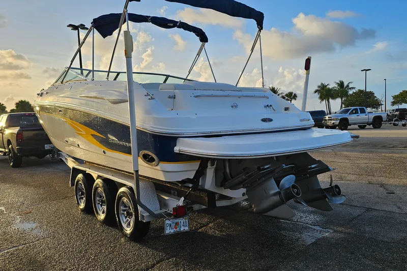 Slide: The Image of 2002 Chaparral 285 SSi boat on trailer, parked in sunny lot with palm trees. - 32