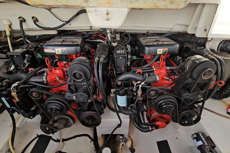 Slide: The Image of Engine compartment of a 2002 Chaparral 285 SSi boat, featuring dual red engines. - 36