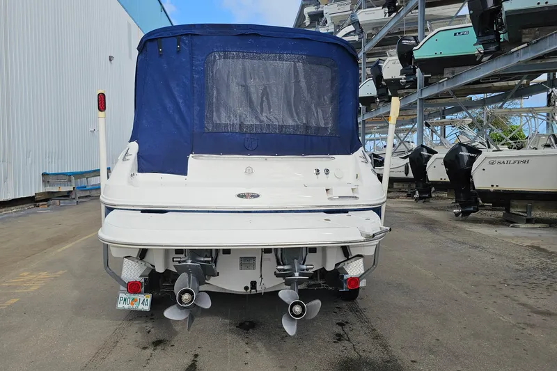Slide: The Image of 2002 Chaparral 285 SSi boat with blue cover, docked in a marina storage area. - 39