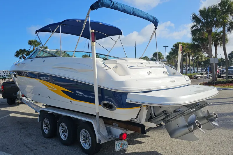 Slide: The Image of 2002 Chaparral 285 SSi boat on trailer, blue and white design, sunny day. - 4
