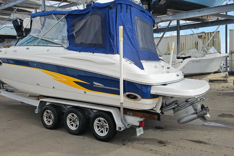 Slide: The Image of 2002 Chaparral 285 SSi boat on trailer with blue cover in storage facility. - 40