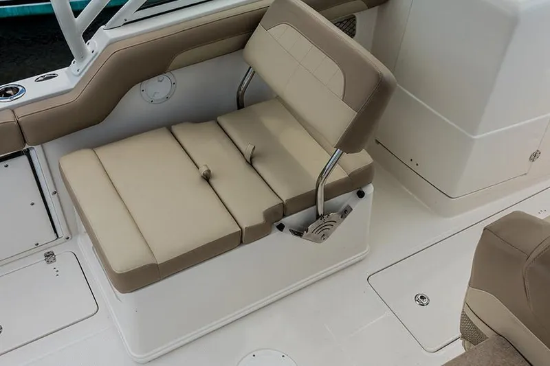 Slide: The Image of 2020 Sailfish 245 DC boat interior with beige seating and safety equipment. - 10
