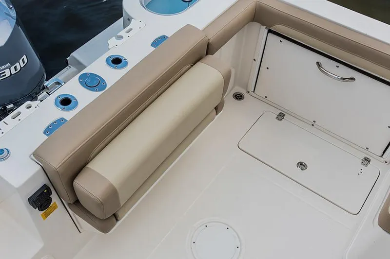 Slide: The Image of Interior of 2020 Sailfish 245 DC boat with beige seating and storage compartments. - 11