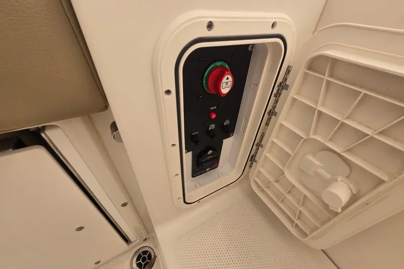 Slide: The Image of Control panel inside a 2020 Sailfish 245 DC boat, featuring a red emergency button. - 18