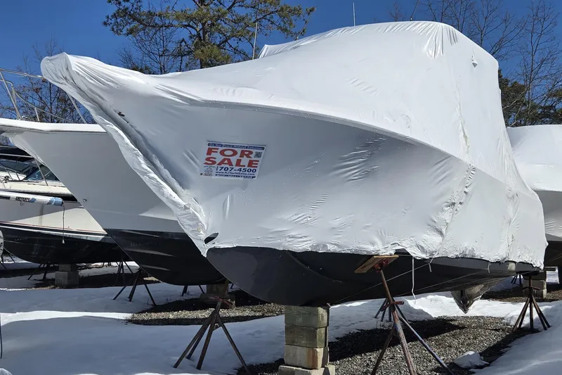 Slide: The Image of Interior of 2020 Sailfish 245 DC boat with beige seating and modern dashboard. - 2