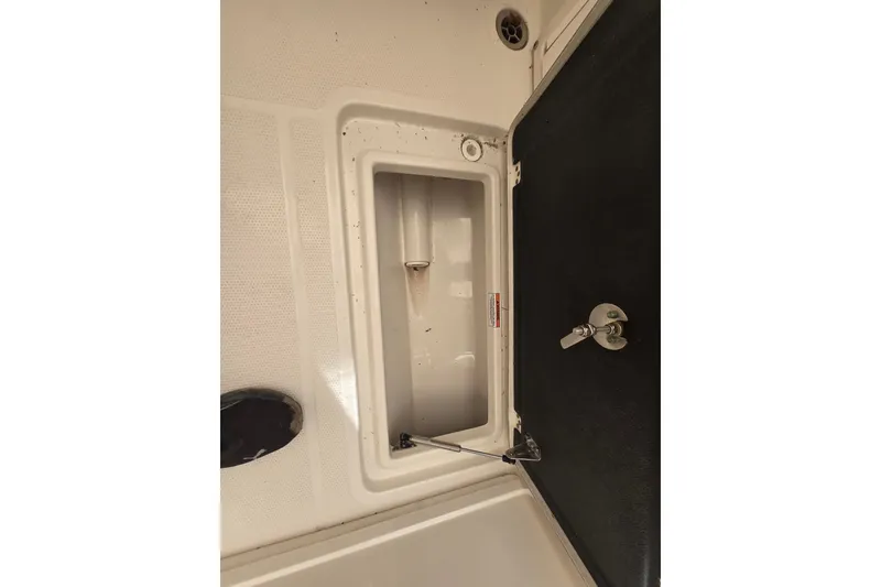 Slide: The Image of Open storage compartment on 2020 Sailfish 245 DC boat. - 22