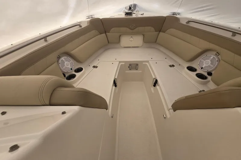Slide: The Image of 2020 Sailfish 245 DC boat interior with beige seating and built-in speakers. - 24