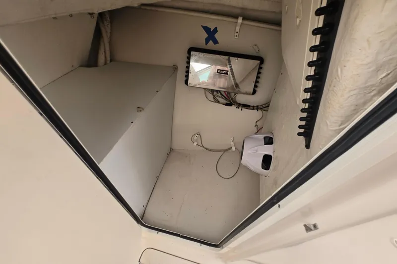 Slide: The Image of Interior cabin of 2020 Sailfish 245 DC boat, featuring storage and electrical components. - 25