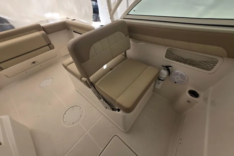 Slide: The Image of 2020 Sailfish 245 DC boat interior with beige seating and safety equipment. - 27