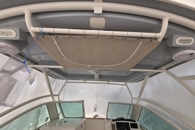 Slide: The Image of Interior view of a 2020 Sailfish 245 DC boat, featuring a canopy and speakers. - 28