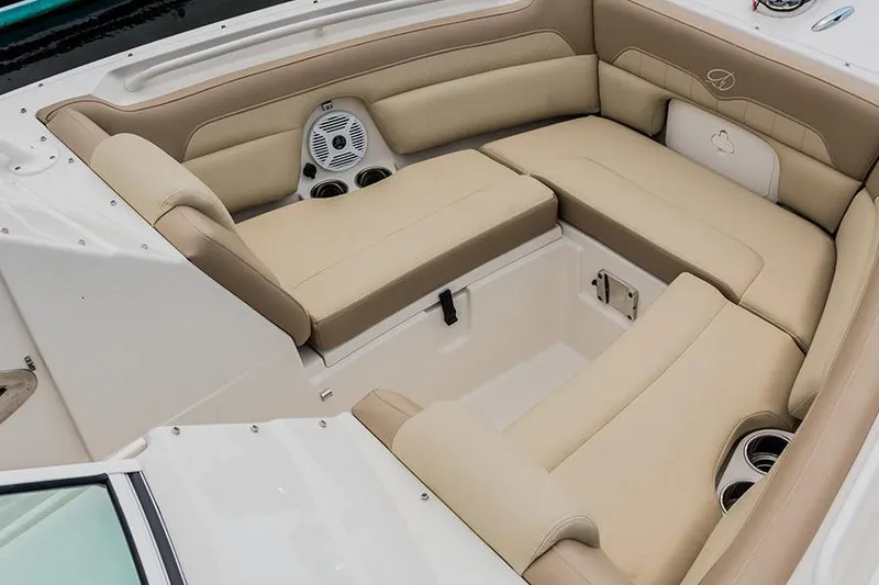 Slide: The Image of Interior of 2020 Sailfish 245 DC boat with beige seating and storage compartments. - 3