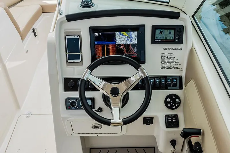 Slide: The Image of 2020 Sailfish 245 DC boat interior with beige seating and cup holders. - 7