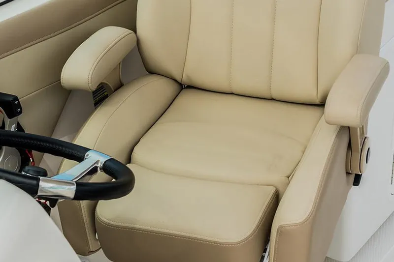 Slide: The Image of 2020 Sailfish 245 DC boat cockpit with Garmin navigation and beige captain's chair. - 8