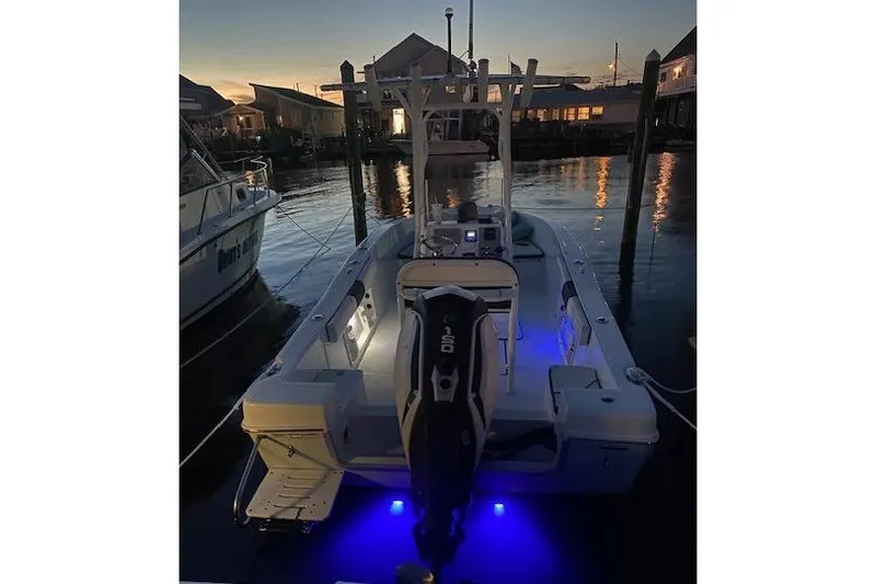 Slide: The Image of 2018 Clearwater 2000 Center Console boat docked at sunset with blue underwater lights. - 3