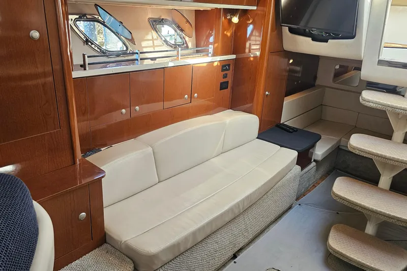 Slide: The Image of Interior of 2008 Sea Ray Sundancer 310 yacht with beige seating and wooden cabinetry. - 10