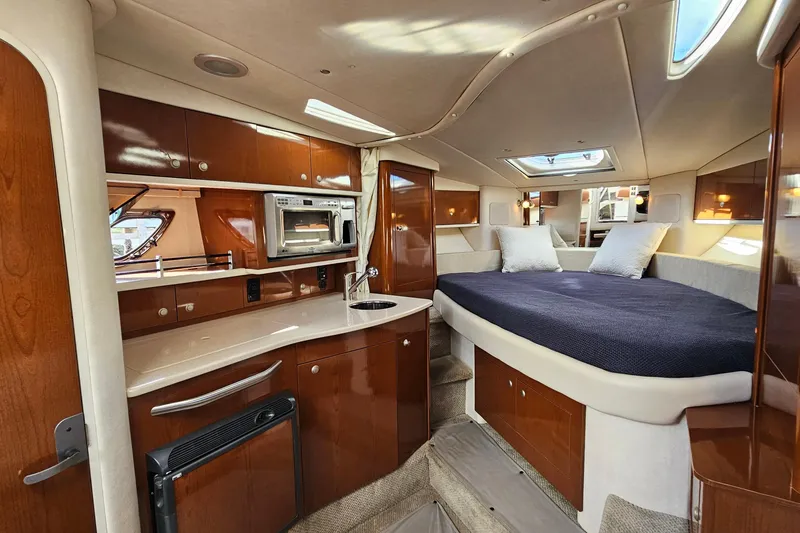 Slide: The Image of 2008 Sea Ray Sundancer 310 interior with kitchenette and cozy sleeping area. - 14