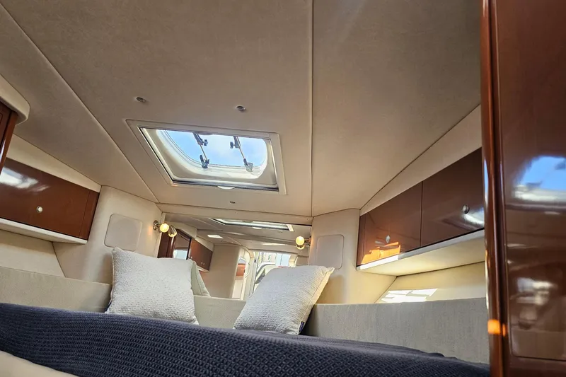 Slide: The Image of Luxurious interior of 2008 Sea Ray Sundancer 310 yacht with skylight and plush bedding. - 16