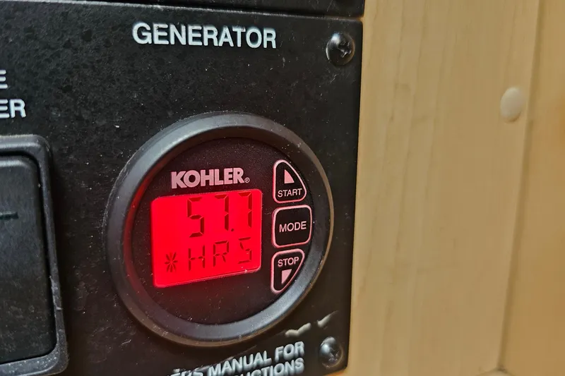 Slide: The Image of Kohler generator display showing 57.1 hours on a 2008 Sea Ray Sundancer 310. - 19