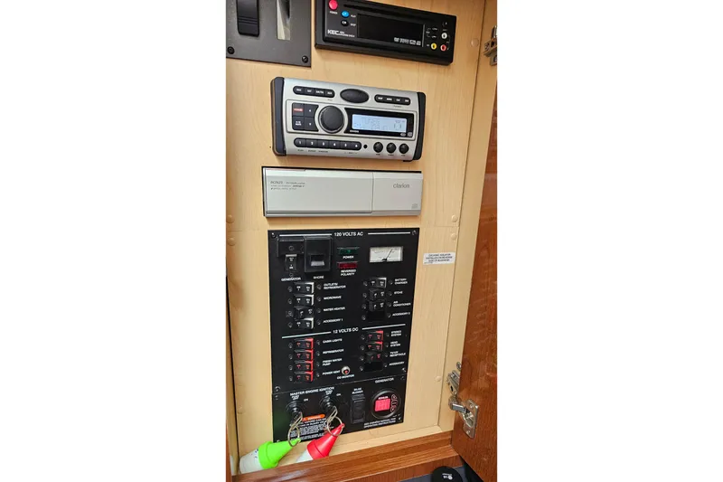 Slide: The Image of Control panel of a 2008 Sea Ray Sundancer 310 boat with audio system and switches. - 20