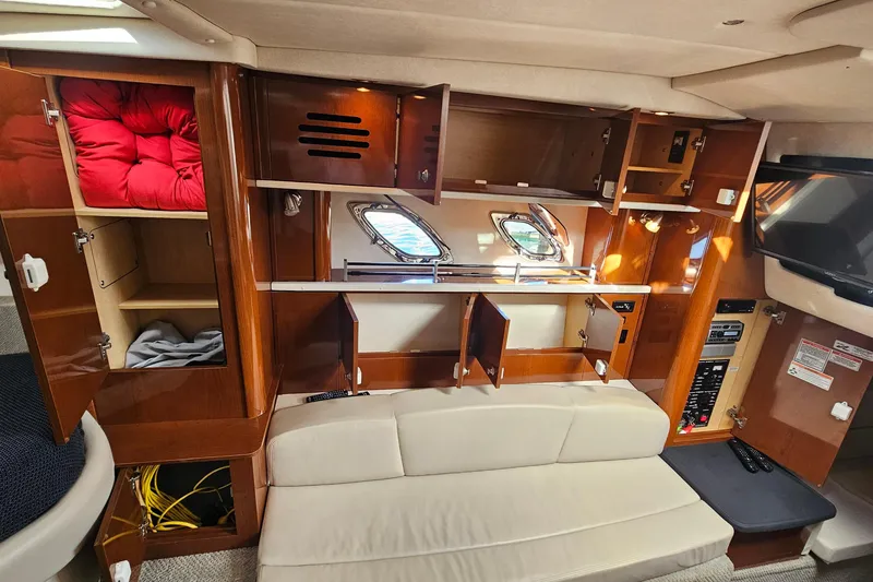 Slide: The Image of Interior of 2008 Sea Ray Sundancer 310 with open cabinets and seating area. - 22