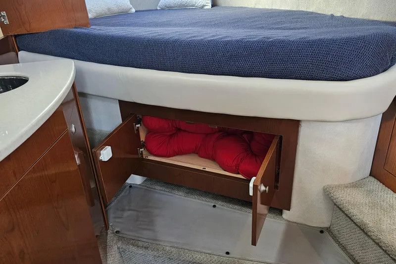 Slide: The Image of 2008 Sea Ray Sundancer 310 cabin with under-bed storage and cozy interior. - 27