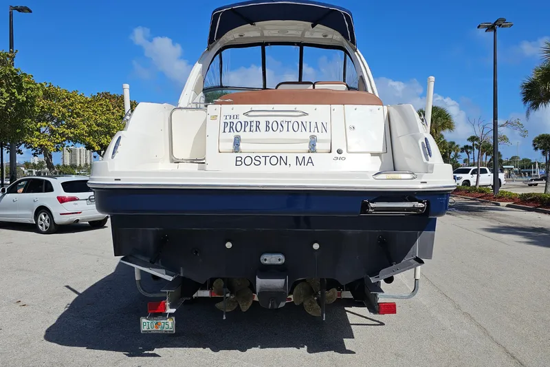 Slide: The Image of 2008 Sea Ray Sundancer 310 boat, "The Proper Bostonian," parked in a sunny marina. - 3