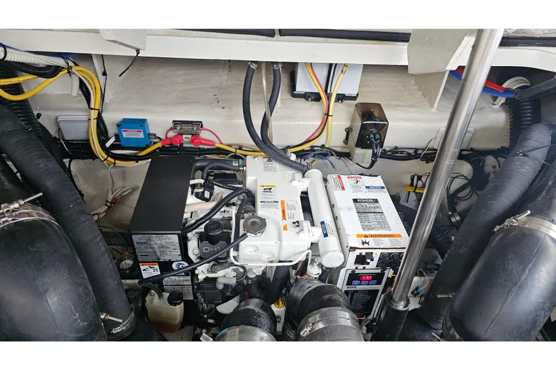 Slide: The Image of Engine compartment of a 2008 Sea Ray Sundancer 310 with visible wiring and components. - 32