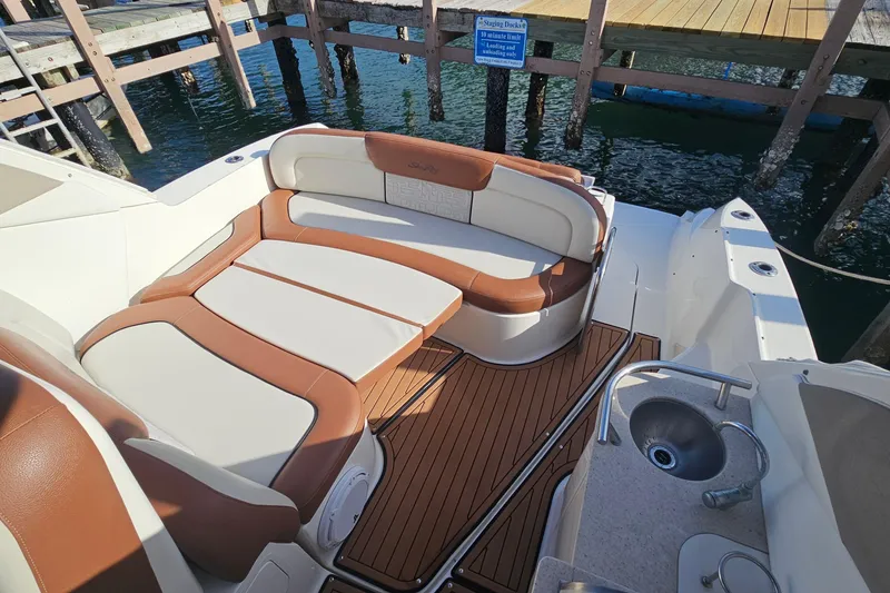 Slide: The Image of 2008 Sea Ray Sundancer 310 boat interior with cushioned seating and wooden deck. - 34