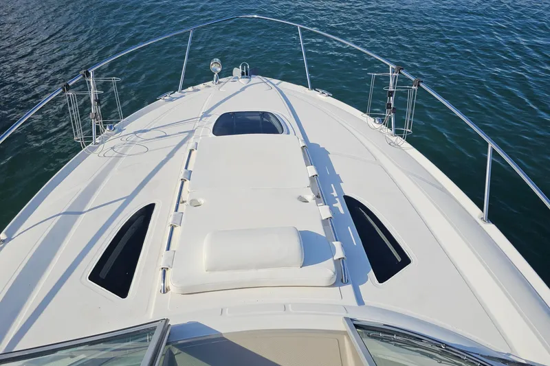 Slide: The Image of 2008 Sea Ray Sundancer 310 boat deck with sleek design on calm water. - 37