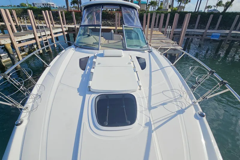 Slide: The Image of 2008 Sea Ray Sundancer 310 yacht docked, showcasing sleek design and spacious deck. - 38