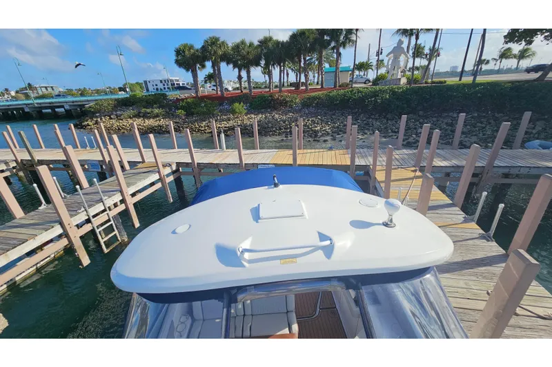 Slide: The Image of 2008 Sea Ray Sundancer 310 docked at marina with palm trees in background. - 40