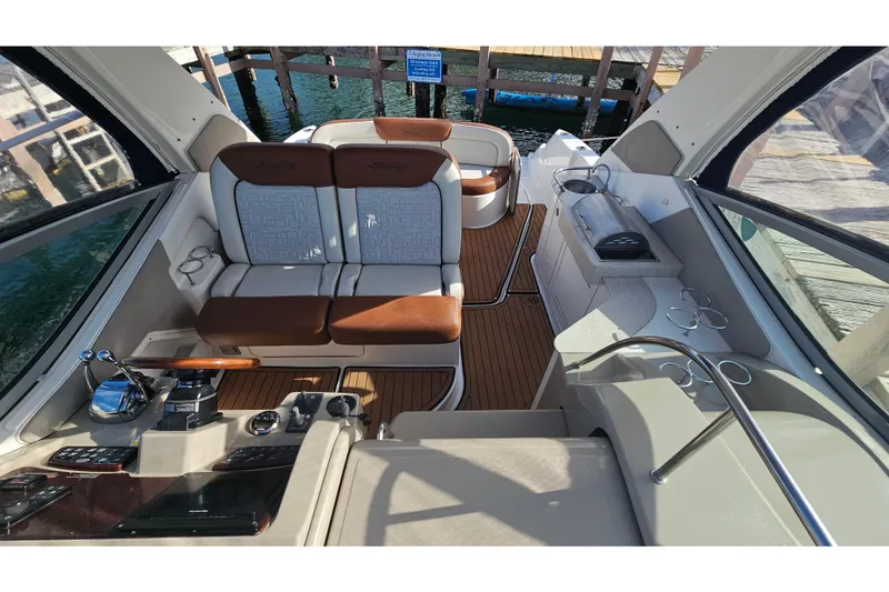Slide: The Image of 2008 Sea Ray Sundancer 310 interior with seating, helm, and wood flooring. - 41
