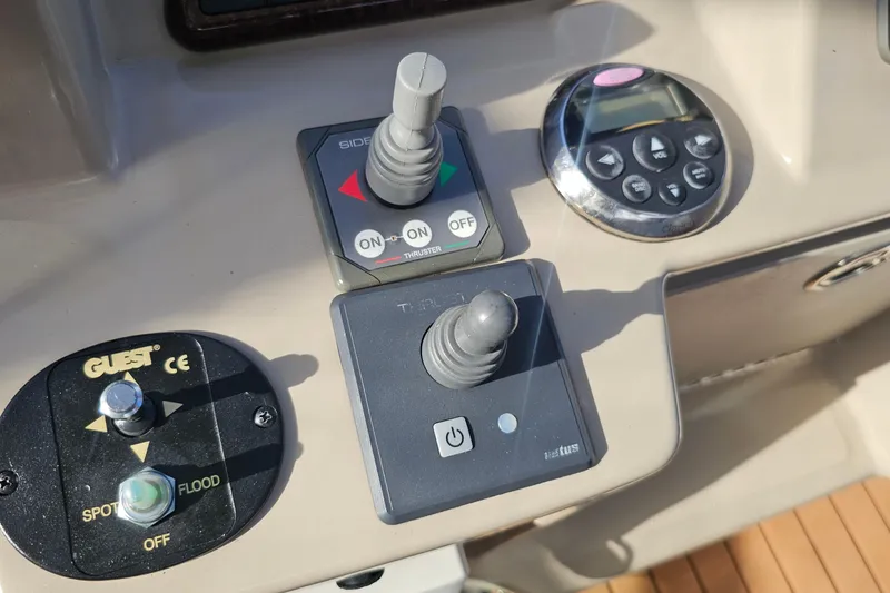 Slide: The Image of Control panel of a 2008 Sea Ray Sundancer 310 boat with joystick and buttons. - 43