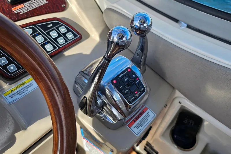 Slide: The Image of Control panel of 2008 Sea Ray Sundancer 310 boat with dual throttle levers. - 44