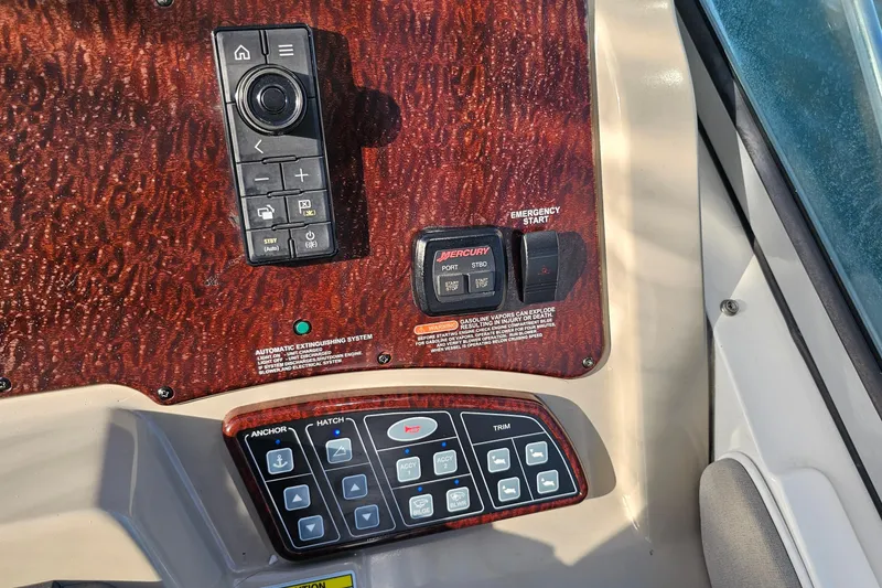 Slide: The Image of Control panel of a 2008 Sea Ray Sundancer 310 boat with various switches and buttons. - 46