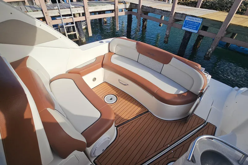Slide: The Image of 2008 Sea Ray Sundancer 310 boat interior with brown and white seating, dockside view. - 53
