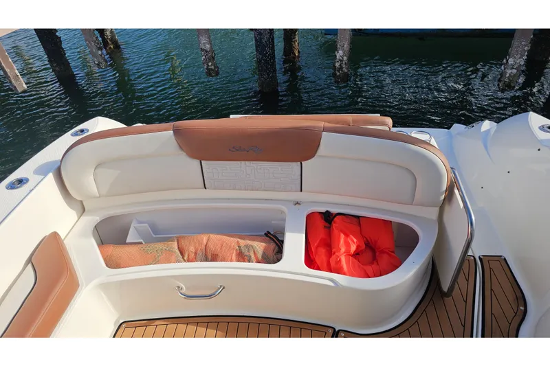Slide: The Image of 2008 Sea Ray Sundancer 310 boat seating area with storage compartments and life jackets. - 54