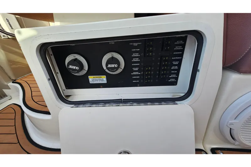 Slide: The Image of Control panel of a 2008 Sea Ray Sundancer 310 boat, featuring switches and gauges. - 56