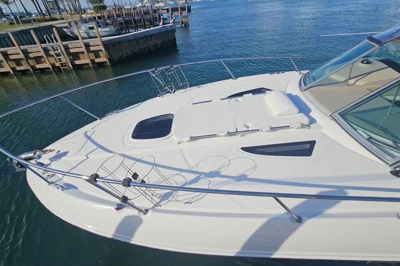 Slide: The Image of 2008 Sea Ray Sundancer 310 yacht docked at marina, featuring sleek white deck design. - 58