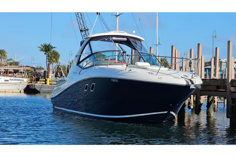 Slide: The Image of 2008 Sea Ray Sundancer 310 yacht docked in a marina under clear blue skies. - 59